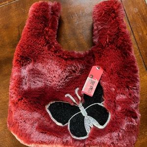 Red faux fur tote with butterfly accent